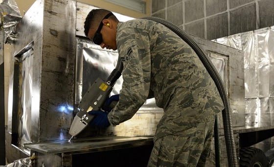 Because using the laser reduces the waste compared to traditional sanding operations, a full protective suit is not needed for workers to operate the machine. Photo by Staff Sgt. Amber Carter, 60th MXS.