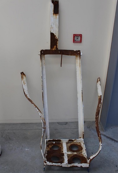 The steel storage frame holding the corroded nitrogen cylinder was damaged during the explosion. Image courtesy of TAIC.