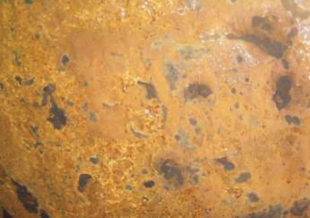 FIGURE 2: Corrosion on the inside of the produced water tank.