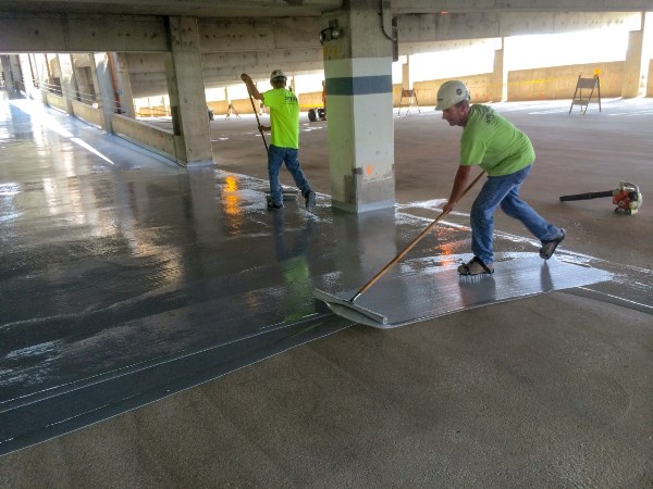The installation of a protective waterproof membrane, as shown here, can prevent many future problems in concrete parking structures. Photo courtesy of Western Specialty Contractors.