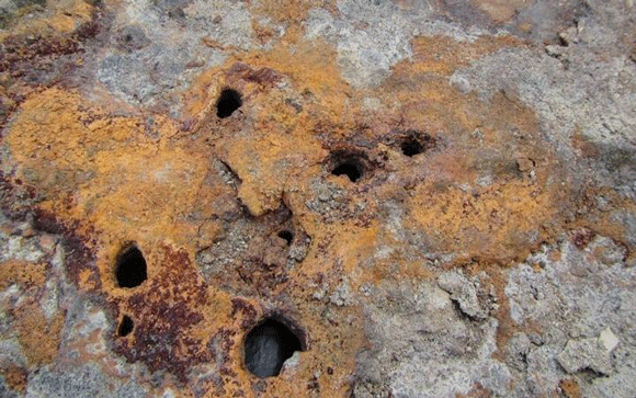 Multiple perforations were seen under the corrosion deposits.