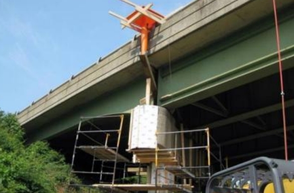 The concrete installation is facilitated by applying pressure through pumping or by pouring from height, such as the use of a funnel here. Photo courtesy of VDOT.
