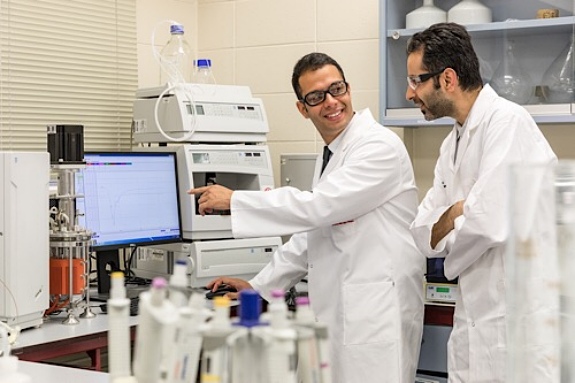 Researchers Aydin Berenjian and Mostafa Seifan study testing results in the lab. Photo courtesy of The University of Waikato.