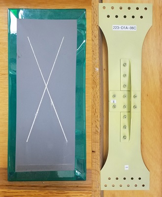 The scribed test sample on the left represents a traditional corrosion testing method, in which researchers etch through both topcoat and primer layers to simulate damage. Meanwhile, the new simulation test chamber enables the full-scale testing of specimens similar to the one on the right by simultaneously subjecting samples to fatigue testing and environmental conditions. Image courtesy of Holly Jordan, U.S. Air Force.