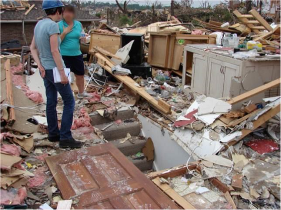 NIST social scientist Erica Kuligowski (left) interviews a tornado survivor in Joplin, Missouri, USA in 2011. Photo courtesy of NIST.