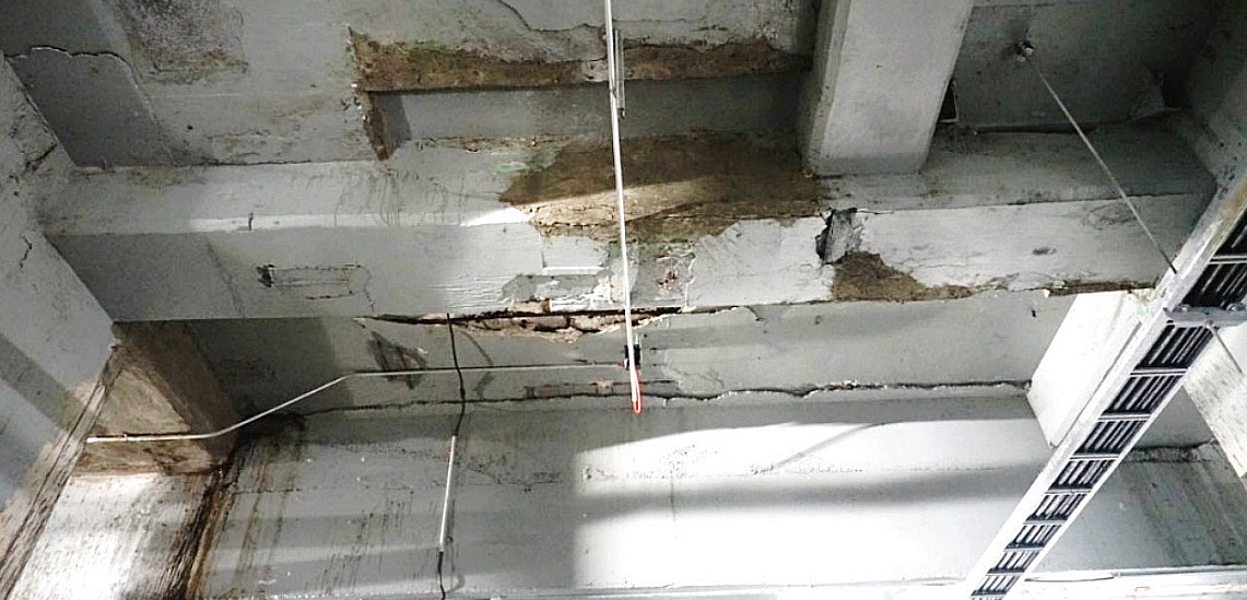 FIGURE 3 Concrete beam exhibiting cracking due to corrosion of rebar and overload.