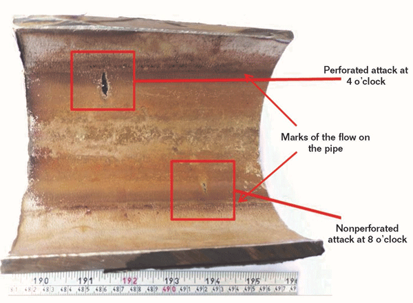 FIGURE 2: A close-up view of the inner surface shows two localized damage zones at nearly 4 and 8 o’clock.
